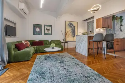 a living room with a green couch and a table at Museum Apartment - Fix A, Athens in Athens