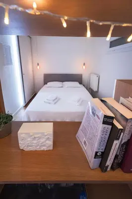 a bedroom with a bed and a book on a table at Museum Apartment - Fix A, Athens in Athens