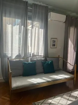 a couch sitting in front of a window at Museum Apartment - Fix A, Athens in Athens