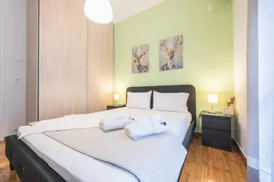 a bedroom with a large bed with two pillows on it at Erythros Boutique Suite By Cloudkeys in Athens
