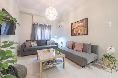 a living room with a couch and a table at Erythros Boutique Suite By Cloudkeys in Athens