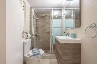 a bathroom with a toilet and a sink and a shower at Erythros Boutique Suite By Cloudkeys in Athens