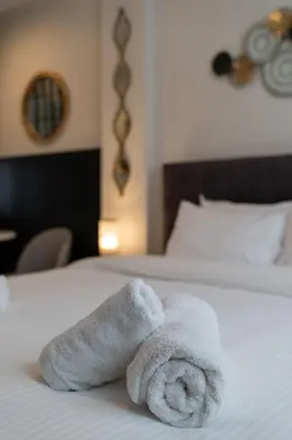 a pile of towels sitting on top of a bed at Dema Luxury Suites - Perikleous E8 in Athens