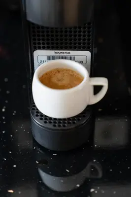 a cup of coffee in a toaster oven at Dema Luxury Suites - Perikleous E8 in Athens