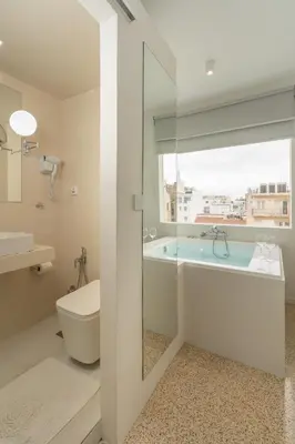 a bathroom with a tub and a toilet and a sink at Dema Luxury Suites - Perikleous E8 in Athens