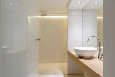 a bathroom with a white sink and a mirror at Elegant 2BD Evelpidon Apartment in Athens