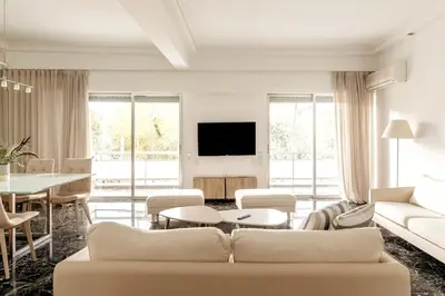 a living room with a couch and a table at Elegant 2BD Evelpidon Apartment in Athens