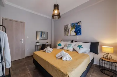 a bedroom with a bed with towels on it at Bijou apartment in Glyfada center in Athens