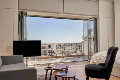 a living room with a large window with a view at Acropolis view penthouse in Athens