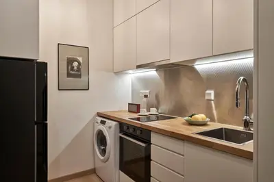 a kitchen with a sink and a washing machine at Acropolis view penthouse in Athens