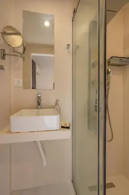 a bathroom with a sink and a shower at Dema Luxury Suites - Lekka E3 in Athens