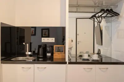 a kitchen with a sink and a counter top at Dema Luxury Suites - Lekka E3 in Athens