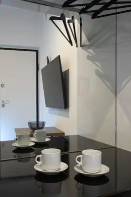 three cups and saucers on a table with a tv at Dema Luxury Suites - Lekka E3 in Athens