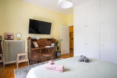 a room with two beds and a flat screen tv at Magnificent Bnb Athens Voula in Athens