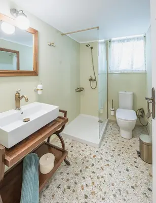 a bathroom with a sink and a shower and a toilet at Magnificent Bnb Athens Voula in Athens