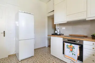 a kitchen with white cabinets and an oven at Magnificent Bnb Athens Voula in Athens