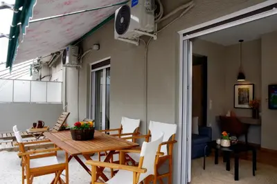 a dining room with a wooden table and chairs at Absolute Athens XIV View in Athens