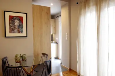 a dining room with a glass table and a window at Absolute Athens XIV View in Athens