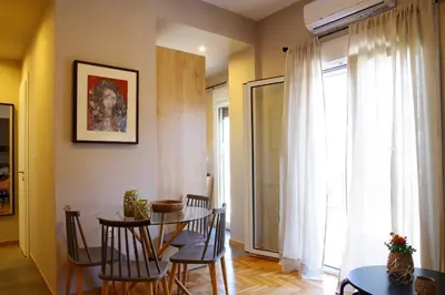 a dining room with a table and chairs and a window at Absolute Athens XIV View in Athens