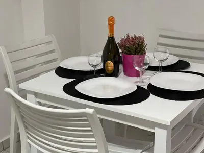 a white table with glasses and a bottle of wine at Athens Studio in Athens