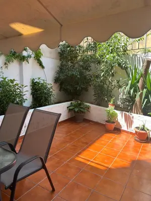 a patio with a chair and potted plants at Athens Studio in Athens