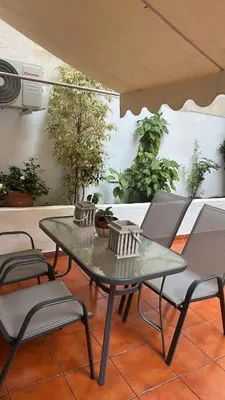a glass table and chairs on a patio at Athens Studio in Athens