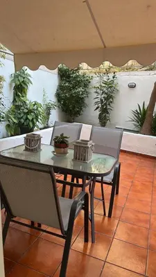 a table and chairs on a patio with plants at Athens Studio in Athens