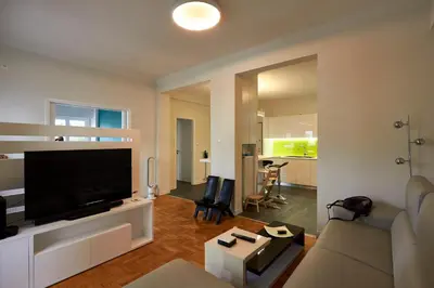 a living room with a large flat screen tv at Fully renovated, family-friendly apartment, next to a huge green park, in Athens center in Athens