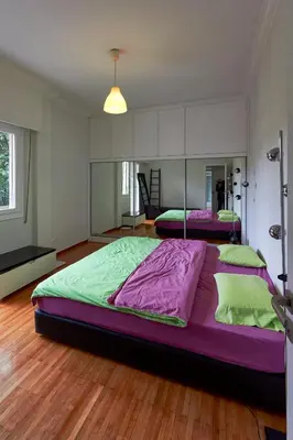 a large bedroom with two large beds in it at Fully renovated, family-friendly apartment, next to a huge green park, in Athens center in Athens