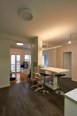 a kitchen and living room with a table and chairs at Fully renovated, family-friendly apartment, next to a huge green park, in Athens center in Athens