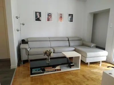 a living room with a couch and a table at Fully renovated, family-friendly apartment, next to a huge green park, in Athens center in Athens