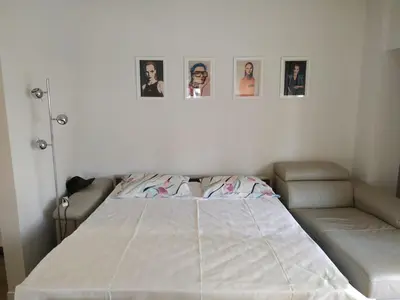 a bed in a room with pictures on the wall at Fully renovated, family-friendly apartment, next to a huge green park, in Athens center in Athens