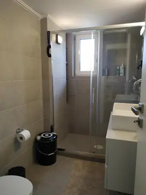 a bathroom with a shower and a toilet and a sink at Fully renovated, family-friendly apartment, next to a huge green park, in Athens center in Athens