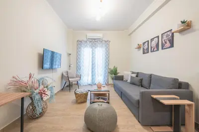 a living room with a couch and a table at Easy Living Suite by Cloudkeys in Athens