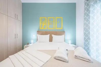 a bedroom with two beds with white pillows at Easy Living Suite by Cloudkeys in Athens
