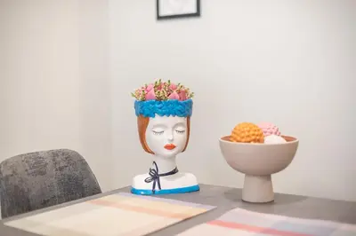a statue sitting on a table next to a bowl of fruit at Easy Living Suite by Cloudkeys in Athens