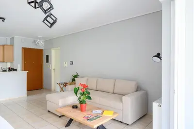 a living room with a couch and a table at The Skyward Flats in Néa Smírni