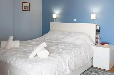 a white bed with two white pillows on it at The Skyward Flats in Néa Smírni