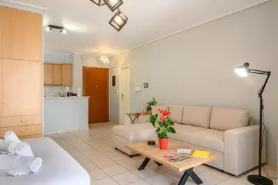 a living room with a couch and a table at The Skyward Flats in Néa Smírni