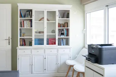 a white hutch with books in it in a room at The Skyward Flats in Néa Smírni