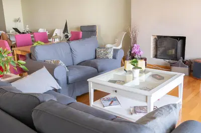 a living room with blue couches and a white table at The Skyward Flats in Néa Smírni