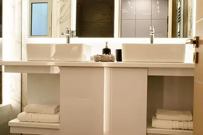 a bathroom with two sinks and two mirrors at Aether Home - Modern & Luxe Stay with 65 TV by TT in Athens