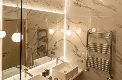 a bathroom with two sinks and a mirror at Aether Home - Modern & Luxe Stay with 65 TV by TT in Athens