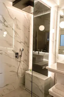 a bathroom with a shower and a sink at Aether Home - Modern & Luxe Stay with 65 TV by TT in Athens
