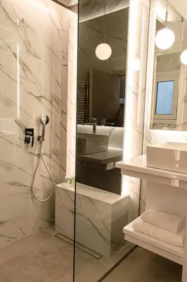 a bathroom with a shower and a sink at Aether Home - Modern & Luxe Stay with 65 TV by TT in Athens