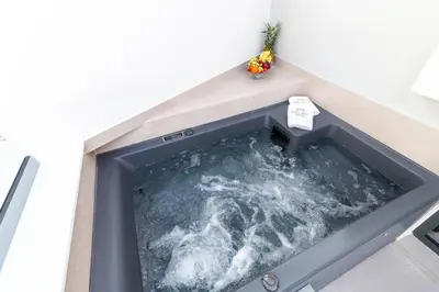 a jacuzzi tub in a room at Paleo Suites in Athens