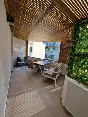 a room with a table and chairs and a window at Paleo Suites in Athens