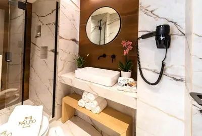 a bathroom with a sink and a mirror at Paleo Suites in Athens