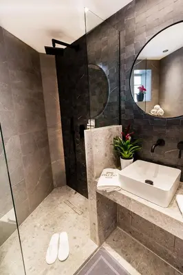 a bathroom with a sink and a mirror at Paleo Suites in Athens