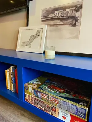 a blue shelf with a picture and books on it at Ultimate Downtown Athens Escape in Athens